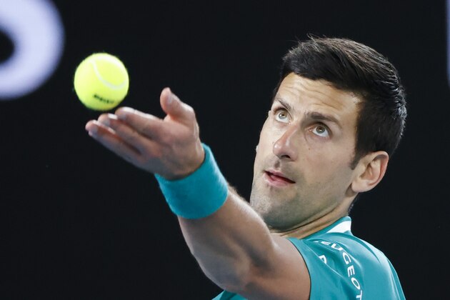 Serbia's Novak Djokovic serves to France's Jeremy Chardy during their first round match at the Australian Open tennis championship in Melbourne, Australia, Monday, Feb. 8, 2021.(AP Photo/Rick Rycroft)