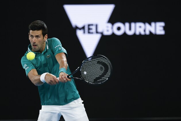 Serbia's Novak Djokovic makes a backhand return to France's Jeremy Chardy during their first round match at the Australian Open tennis championship in Melbourne, Australia, Monday, Feb. 8, 2021. (AP Photo/Rick Rycroft)