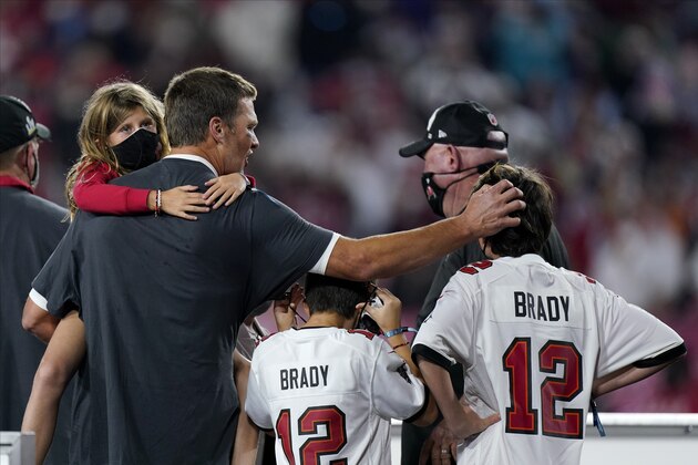 Tampa Bay Buccaneers quarterback Tom Brady celebrates with his children after the NFL Super Bowl 55 football game against the Kansas City Chiefs, Sunday, Feb. 7, 2021, in Tampa, Fla. The Buccaneers defeated the Chiefs 31-9 to win the Super Bowl. (AP Photo/Mark Humphrey)