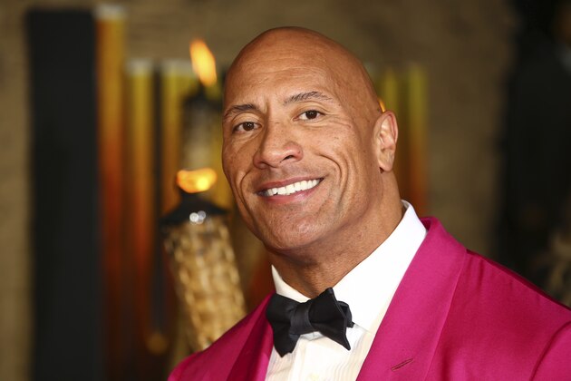 FILE - In this Dec. 5, 2019 file photo, actor Dwayne Johnson poses for photographers upon arrival at the premiere of the film 'Jumanji The Next Level', in central London.   Johnson will revisit his younger years in a new NBC comedy series called “The Rock,” which is the retired pro wrestler's nickname. NBC said Saturday, Jan. 11, 2020  that it's ordered 11 episodes of the show inspired by Johnson, who will appear and also serve as an executive producer.  (Photo by Joel C Ryan/Invision/AP)