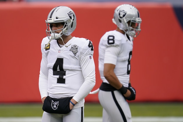 Las Vegas Raiders quarterback Derek Carr (4) and quarterback Marcus Mariota (8) warm up before an NFL football game against the Denver Broncos, Sunday, Jan. 3, 2021, in Denver. (AP Photo/David Zalubowski)