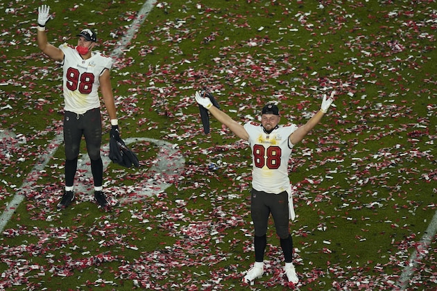 Tampa Bay Buccaneers' Anthony Nelson (98) and tight end Tanner Hudson (88) celebrate on the field at the end of the NFL Super Bowl 55 football game against the Kansas City Chiefs, Sunday, Feb. 7, 2021, in Tampa, Fla. The Buccaneers defeated the Chiefs 31-9 to win the Super Bowl. (AP Photo/Charlie Riedel)