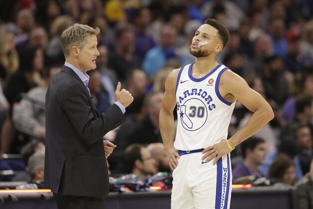 Golden State Warriors head coach Steve Kerr talks with Warriors guard Stephen Curry during the first quarter of an NBA basketball game against the Sacramento Kings Friday, Feb. 2, 2018, in Sacramento, Calif. The Warriors won 119-104. (AP Photo/Rich Pedroncelli)
