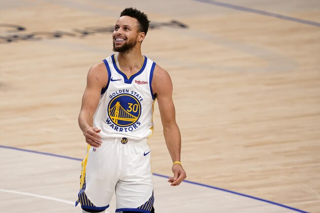 Golden State Warriors' Stephen Curry (30) smiles after being charged with a foul during an NBA basketball game against the Dallas Mavericks in Dallas, Saturday, Feb. 6, 2021. (AP Photo/Tony Gutierrez)