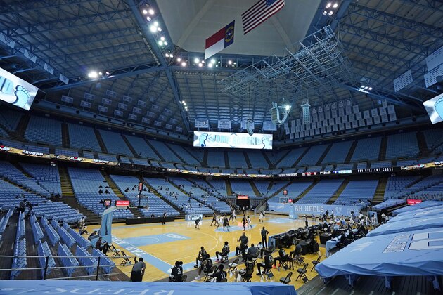 North Carolina and College of Charleston tip off in front a limited crowd due to COVID-19 restrictions, at the Dean E. Smith Center during the first half of an NCAA basketball game in Chapel Hill, N.C., Wednesday, Nov. 25, 2020. (AP Photo/Gerry Broome) North Carolina and College of Charleston tip off in front a limited crowd due to COVID-19 restrictions, at the Dean E. Smith Center during the first half of an NCAA basketball game in Chapel Hill, N.C., Wednesday, Nov. 25, 2020. (AP Photo/Gerry Broome)