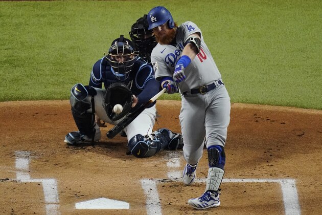 Los Angeles Dodgers' Justin Turner hits a home run against the Tampa Bay Rays during the first inning in Game 4 of the baseball World Series Saturday, Oct. 24, 2020, in Arlington, Texas. (AP Photo/Sue Ogrocki)