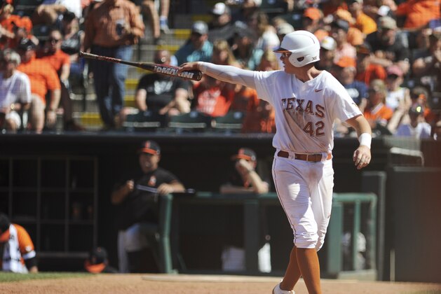 In this May 28, 2017, photo, Texas' Kacy Clemens celebrates after scoring a run in the championship game in the Big 12 baseball tournament in Oklahoma City. Thirty-four years after Texas and pitcher Roger Clemens won the College World Series, two younger Clemenses are chasing another title with the Longhorns. (AP Photo/Kyle Phillips)