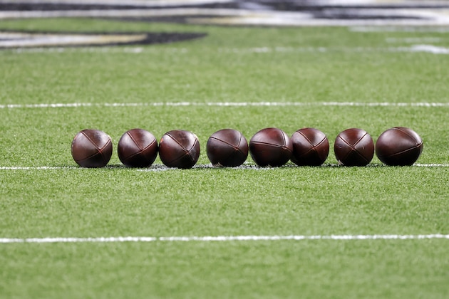 Footballs are seen on the field before an NFL wild-card playoff football game between the New Orleans Saints and the Chicago Bears, Sunday, Jan. 10, 2021, in New Orleans. The Saints defeated the Bears 21-9. (AP Photo/Tyler Kaufman)