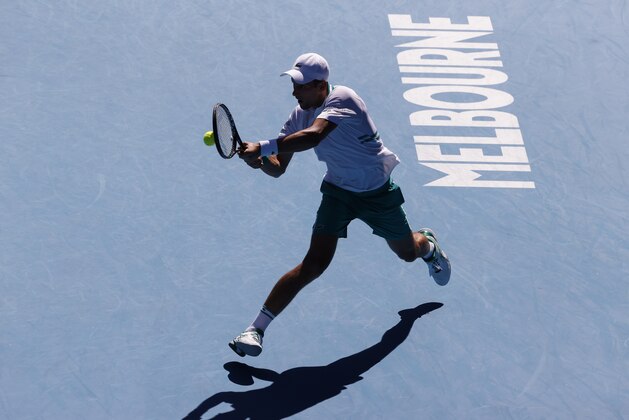 Serbia's Novak Djokovic makes a backhand return to United States' Frances Tiafoe during their second round match at the Australian Open tennis championship in Melbourne, Australia, Wednesday, Feb. 10, 2021.(AP Photo/Rick Rycroft)