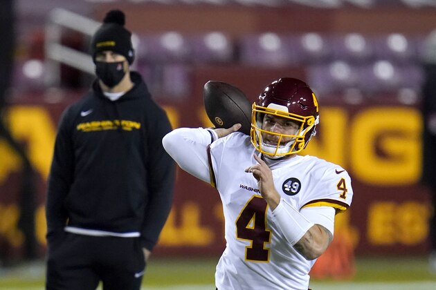 With Washington Football Team quarterback Alex Smith, back left, looking, quarterback Taylor Heinicke (4) works out prior to an NFL wild-card playoff football game against the Tampa Bay Buccaneers, Saturday, Jan. 9, 2021, in Landover, Md. Tampa Bay won 31-23. (AP Photo/Julio Cortez)