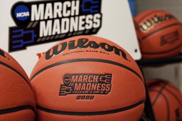 FILE - In this March 16, 2020, file photo, official March Madness 2020 tournament basketballs are displayed in a storeroom at the CHI Health Center Arena, in Omaha, Neb. The dominos started tumbling in March, when the NCAA abruptly called off March Madness, given no choice but to forgo a nearly $800 million TV payment that helps keep the entire college sports machine running. (AP Photo/Nati Harnik, File)