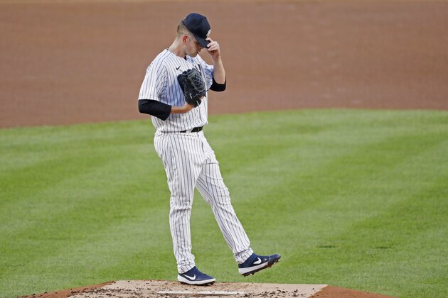 New York Yankees starting pitcher James Paxton reacts after allowing a double to Boston Red Sox's J.D. Martinez during the first inning of a baseball game, Sunday, Aug. 2, 2020, at Yankee Stadium in New York. (AP Photo/Kathy Willens)