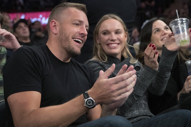 Former New York Knicks forward David Lee, left, and Danish tennis player Caroline Wozniacki applaud during a timeout in the second half of an NBA basketball game between the Knicks and the Denver Nuggets, Thursday, Dec. 5, 2019, at Madison Square Garden in New York. (AP Photo/Mary Altaffer)