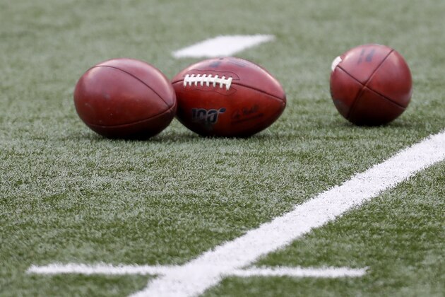 Footballs are on the field as the teams warm up before an NFL football game between the Cincinnati Bengals and the Baltimore Ravens, Sunday, Jan. 3, 2021, in Cincinnati. (AP Photo/Aaron Doster)
