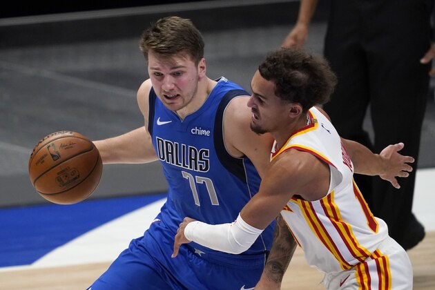 Dallas Mavericks' Luka Doncic (77) works against Atlanta Hawks' Trae Young (11) for a shot opportunity in the second half of an NBA basketball game in Dallas, Wednesday, Feb. 10, 2021. (AP Photo/Tony Gutierrez)