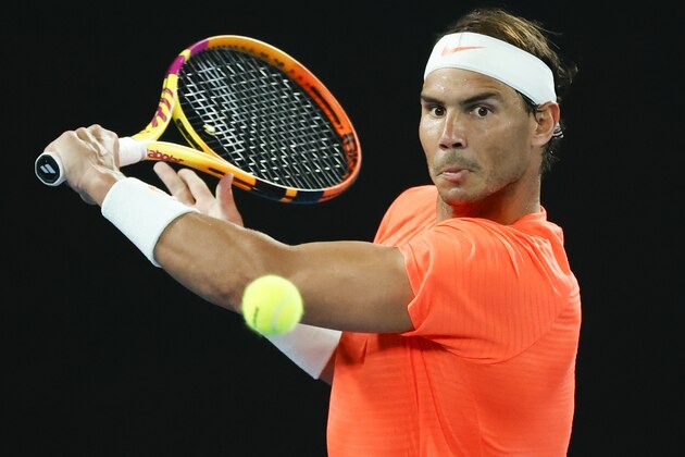 Spain's Rafael Nadal makes a backhand return to United States' Michael Mmoh during their second round match at the Australian Open tennis championship in Melbourne, Australia, Thursday, Feb. 11, 2021.(AP Photo/Rick Rycroft)