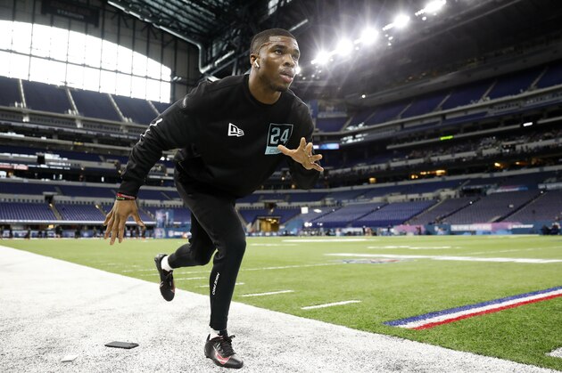Ohio State defensive back Jeff Okudah stretches at the NFL football scouting combine in Indianapolis, Sunday, March 1, 2020. (AP Photo/Charlie Neibergall)