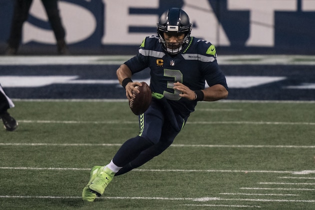 Seattle Seahawks quarterback Russell Wilson runs with the ball during the second half of an NFL wild-card playoff football game against the Los Angeles Rams, Saturday, Jan. 9, 2021, in Seattle. The Rams won 30-20. (AP Photo/Stephen Brashear)
