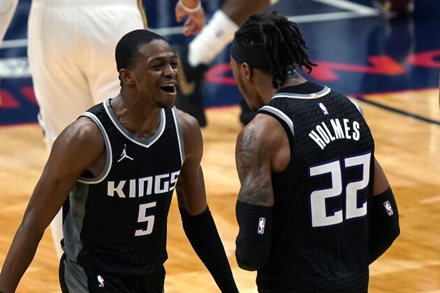 Sacramento Kings guard De'Aaron Fox (5) celebrates with center Richaun Holmes (22) after scoring a basket late in the second half of an NBA basketball game against the New Orleans Pelicans in New Orleans, Monday, Feb. 1, 2021. (AP Photo/Gerald Herbert)