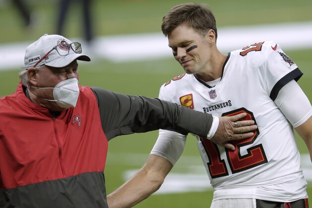 ARCHIVO - En imagen de archivo del 17 de enero de 2021, el coach de los Buccaneers de Tampa Bay, Bruce Arians, izquierda, conversa con el quarterback Tom Brady antes del partido de la ronda divisional de los playoffs de la NFL frente a los Saints, en Nueva Orleans. (AP Foto/Brett Duke, archivo)