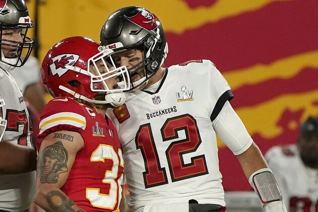 Tampa Bay Buccaneers quarterback Tom Brady (12) talks with Kansas City Chiefs strong safety Tyrann Mathieu (32) after throwing a touchdown pass during the first half of the NFL Super Bowl 55 football game Sunday, Feb. 7, 2021, in Tampa, Fla. (AP Photo/Gregory Bull)
