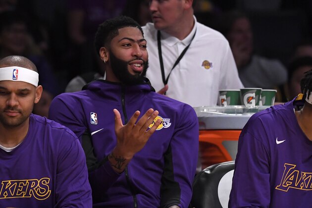 Los Angeles Lakers forward Anthony Davis gestures as he sits on the bench during the second half of a preseason against the Golden State Warriors NBA basketball game Monday, Oct. 14, 2019, in Los Angeles. The Lakers won 104-98. (AP Photo/Mark J. Terrill)