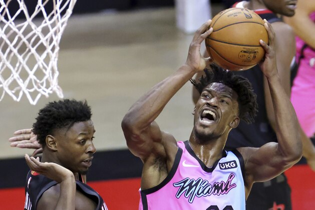 Miami Heat's Jimmy Butler shoots next to Houston Rockets' Jae'Sean Tate during the first quarter of an NBA basketball game Thursday, Feb. 11, 2021, in Houston. (Carmen Mandato/Pool Photo via AP) Miami Heat's Jimmy Butler shoots next to Houston Rockets' Jae'Sean Tate during the first quarter of an NBA basketball game Thursday, Feb. 11, 2021, in Houston. (Carmen Mandato/Pool Photo via AP)