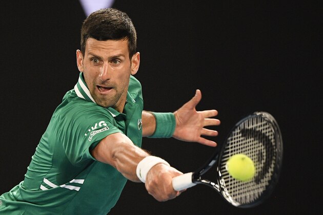 Serbia's Novak Djokovic makes a backhand return during his third round match against United States' Talyor Fritz at the Australian Open tennis championship in Melbourne, Australia, Friday, Feb. 12, 2021.(AP Photo/Andy Brownbill)