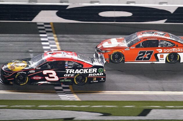 Austin Dillon (3) crosses the finish line in front of Bubba Wallace (23) to win the second of two qualifying auto races for the NASCAR Daytona 500 at Daytona International Speedway, early Friday, Feb. 12, 2021, in Daytona Beach, Fla. (AP Photo/John Raoux)