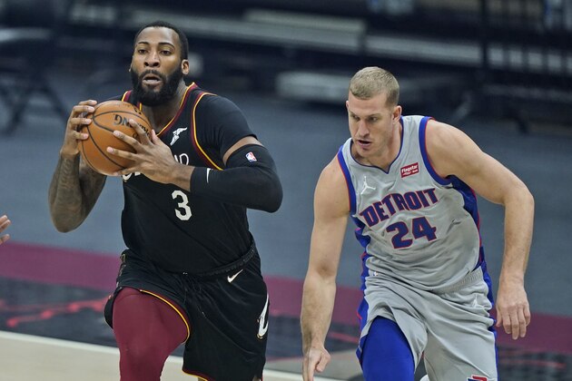 Cleveland Cavaliers' Andre Drummond (3) drive against Detroit Pistons' Mason Plumlee (24) in the first half of an NBA basketball game, Wednesday, Jan. 27, 2021, in Cleveland. (AP Photo/Tony Dejak)