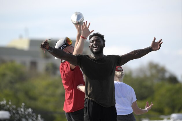 Tampa Bay Buccaneers wide receiver Chris Godwin, front, celebrates as tight end Tanner Hudson raises the Vince Lombardi trophy during a celebration of their Super Bowl 55 victory over the Kansas City Chiefs with a boat parade, Wednesday, Feb. 10, 2021, in Tampa, Fla. (AP Photo/Phelan M. Ebenhack)