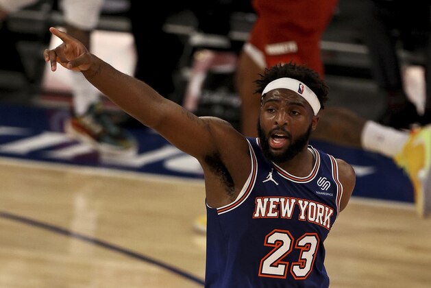 New York Knicks' Mitchell Robinson celebrates his dunk against the Denver Nuggets in the second half of an NBA basketball game Sunday, Jan. 10, 2021, in New York. (Elsa/Pool Photo via AP)