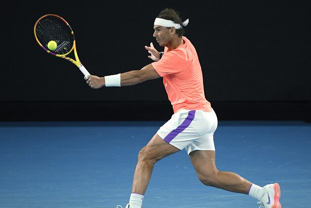 Spain's Rafael Nadal hits a backhand to Britain's Cameron Norrie during their third round match a the Australian Open tennis championships in Melbourne, Australia, Saturday, Feb. 13, 2021. (AP Photo/Andy Brownbill)