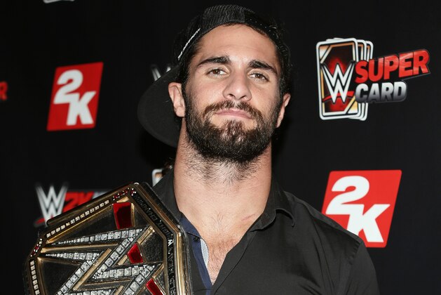 IMAGE DISTRIBUTED FOR 2K - WWE World Heavyweight Champion Seth Rollins poses with his championship title at the WWE 2K SummerSlam Kickoff in New York, N.Y., on Thursday, Aug. 20, 2015. (Photo by Stuart Ramson/Invision for 2K/AP Images)
