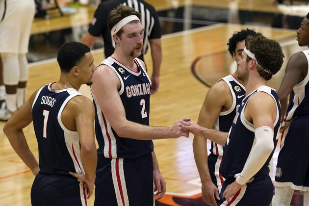 FILE - In this Feb. 4, 2021, file photo, Gonzaga's Drew Timme, second from left, and Corey Kispert shake hands in the closing moments of Gonzaga's 76-58 win over Pacific in an NCAA college basketball game in Stockton, Calif. Gonzaga coach Mark Few isn't being asked questions about where his team should be seeded for next month's NCAA Men's Basketball Tournament. Instead, the longtime coach is getting a different question with a little more than a month until Selection Sunday â€” does it make any sense for Gonzaga to compete in its conference tournament? (AP Photo/Rich Pedroncelli, File)
