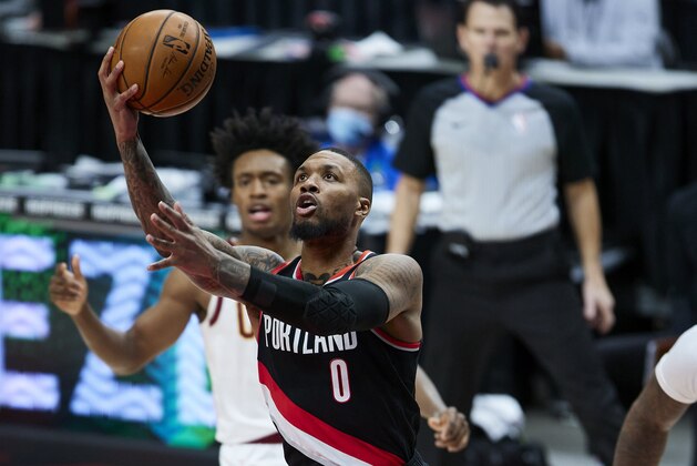 Portland Trail Blazers guard Damian Lillard (0) shoots against the Cleveland Cavaliers during the second half of an NBA basketball game in Portland, Ore., Friday, Feb. 12, 2021. (AP Photo/Craig Mitchelldyer)
