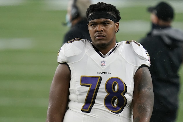 Baltimore Ravens offensive lineman Orlando Brown Jr. watches from the sideline in the first half of an NFL football game against the New England Patriots, Sunday, Nov. 15, 2020, in Foxborough, Mass. (AP Photo/Charles Krupa)