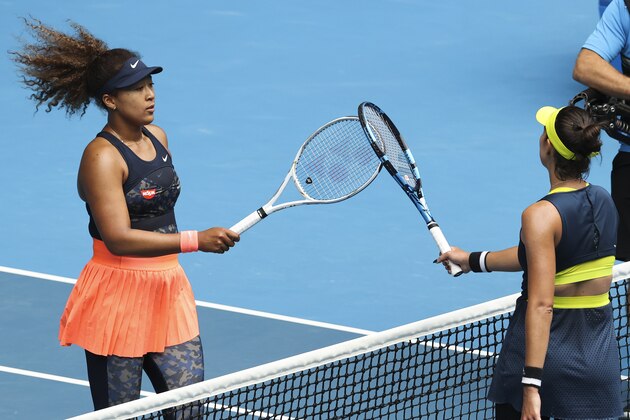 Japan's Naomi Osaka, left, is congratulated by Spain's Garbine Muguruza after winning their fourth round match at the Australian Open tennis championship in Melbourne, Australia, Sunday, Feb. 14, 2021.(AP Photo/Hamish Blair)