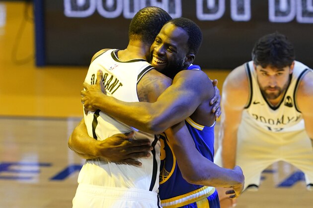 Brooklyn Nets forward Kevin Durant, left, hugs Golden State Warriors forward Draymond Green before an NBA basketball game in San Francisco, Saturday, Feb. 13, 2021. (AP Photo/Jeff Chiu)
