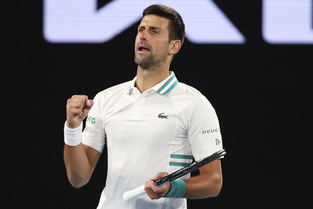 Serbia's Novak Djokovic celebrates after defeating Canada's Milos Raonic during their fourth round match at the Australian Open tennis championship in Melbourne, Australia, Sunday, Feb. 14, 2021.(AP Photo/Hamish Blair)