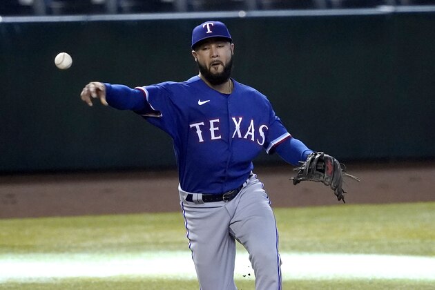 FILE - In this Sept. 23, 2020, file photo, Texas Rangers' Isiah Kiner-Falefa fields throws to first after fielding a ground ball during the first inning of a baseball game Arizona Diamondbacks in Phoenix. The Rangers will give Gold Glove-winning third baseman Isiah Kiner-Falefa the opportunity to be their starting shortstop next season, and have told Elvis Andrus to prepare to play all infield positions.   (AP Photo/Matt York, File)