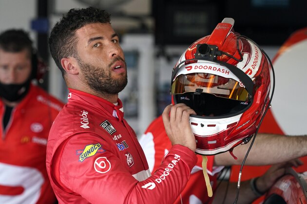 Bubba Wallace removes his helmet in his garage after a NASCAR Daytona 500 auto race practice session at Daytona International Speedway, Wednesday, Feb. 10, 2021, in Daytona Beach, Fla. Wallace turned the fastest time for the practice session. (AP Photo/John Raoux)
