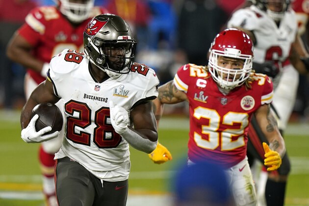 Tampa Bay Buccaneers running back Leonard Fournette (28) runs the ball as Kansas City Chiefs strong safety Tyrann Mathieu (32) pursues during the first half of the NFL Super Bowl 55 football game Sunday, Feb. 7, 2021, in Tampa, Fla. (AP Photo/Lynne Sladky)