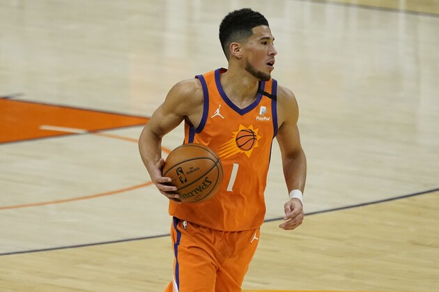 Phoenix Suns guard Devin Booker (1) against the Detroit Pistons during the second half of an NBA basketball game, Friday, Feb. 5, 2021, in Phoenix. (AP Photo/Matt York)