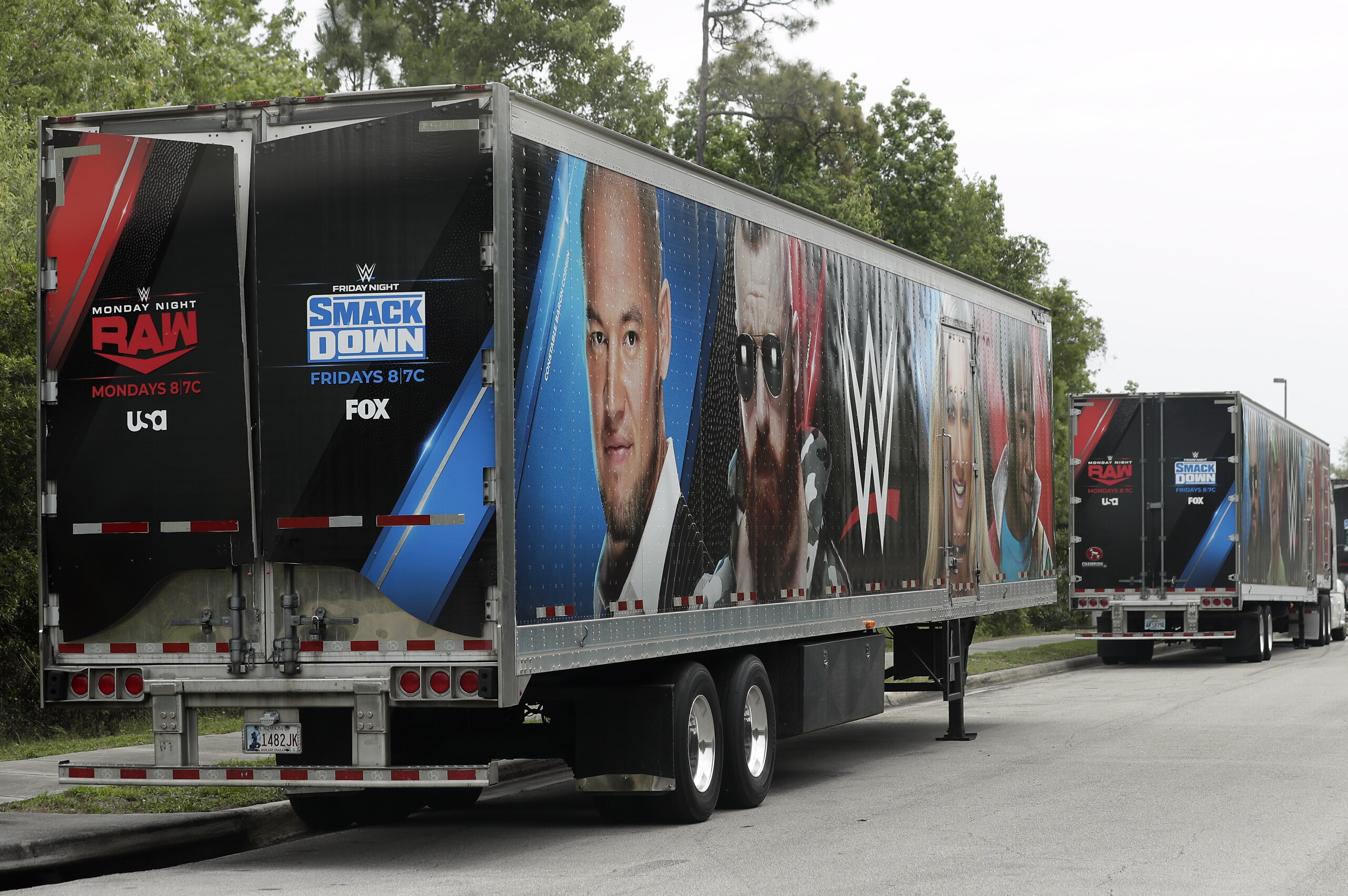 Equipment trailers are lined up at the entrance road to the WWE Performance Center Tuesday, April 14, 2020, in Orlando, Fla. Florida’s top emergency official last week amended Gov. Ron DeSantis’ stay-at-home order to include employees at the professional sports and media production with a national audience, if the location is closed to the public. (AP Photo/John Raoux) Equipment trailers are lined up at the entrance road to the WWE Performance Center Tuesday, April 14, 2020, in Orlando, Fla. Florida’s top emergency official last week amended Gov. Ron DeSantis’ stay-at-home order to include employees at the professional sports and media production with a national audience, if the location is closed to the public. (AP Photo/John Raoux)