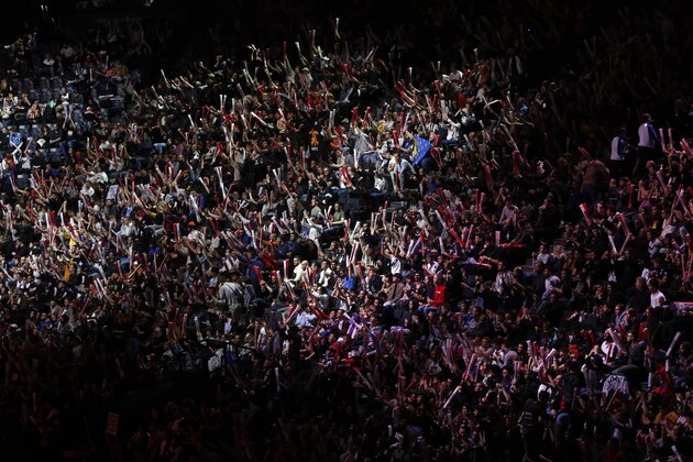 Spectateurs watch the final of League of Legends tournament between Team G2 Esports and Team FunPlus Phoenix, in Paris, Sunday, Nov. 10, 2019. The biggest e-sports event of the year saw a Chinese team, FunPlus Phoenix, crowned as world champions of the video game League of Legends. Thousands of fans packed a Paris arena for the event, which marked another step forward for the growing esports business. (AP Photo/Thibault Camus)