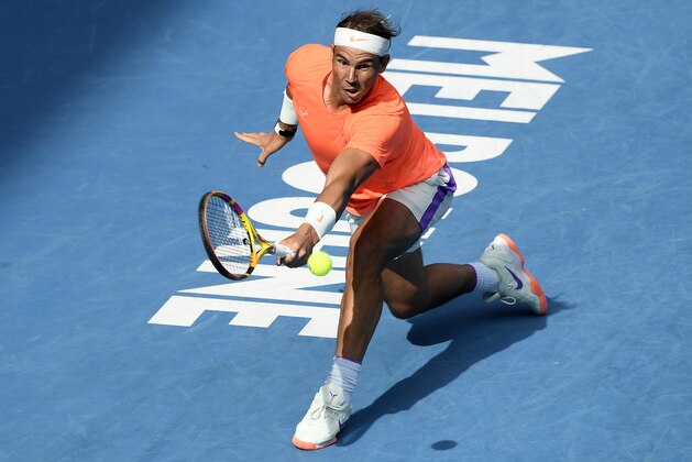 Spain's Rafael Nadal hits a backhand return to Italy's Fabio Fognini during their fourth round match at the Australian Open tennis championship in Melbourne, Australia, Monday, Feb. 15, 2021.(AP Photo/Andy Brownbill)