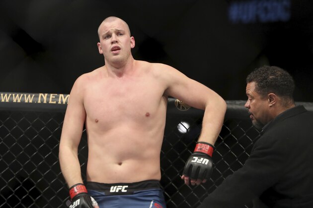 Stefan Struve is checked out by a doctor after absorbing a low blow by Ben Rothwell during their mixed martial arts bout at UFC Fight Night, Saturday, December 7, 2019, in Washington, D.C. Rothwell won via 2nd round stoppage. (AP Photo/Gregory Payan)