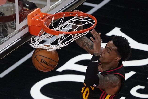 Atlanta Hawks forward John Collins (20) scores against the Los Angeles Lakers in the first half of an NBA basketball game, Monday, Feb. 1, 2021, in Atlanta. (AP Photo/John Bazemore)