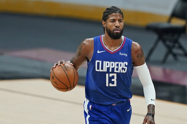 Los Angeles Clippers' Paul George drives in the second half of an NBA basketball game against the Cleveland Cavaliers, Wednesday, Feb. 3, 2021, in Cleveland. (AP Photo/Tony Dejak)